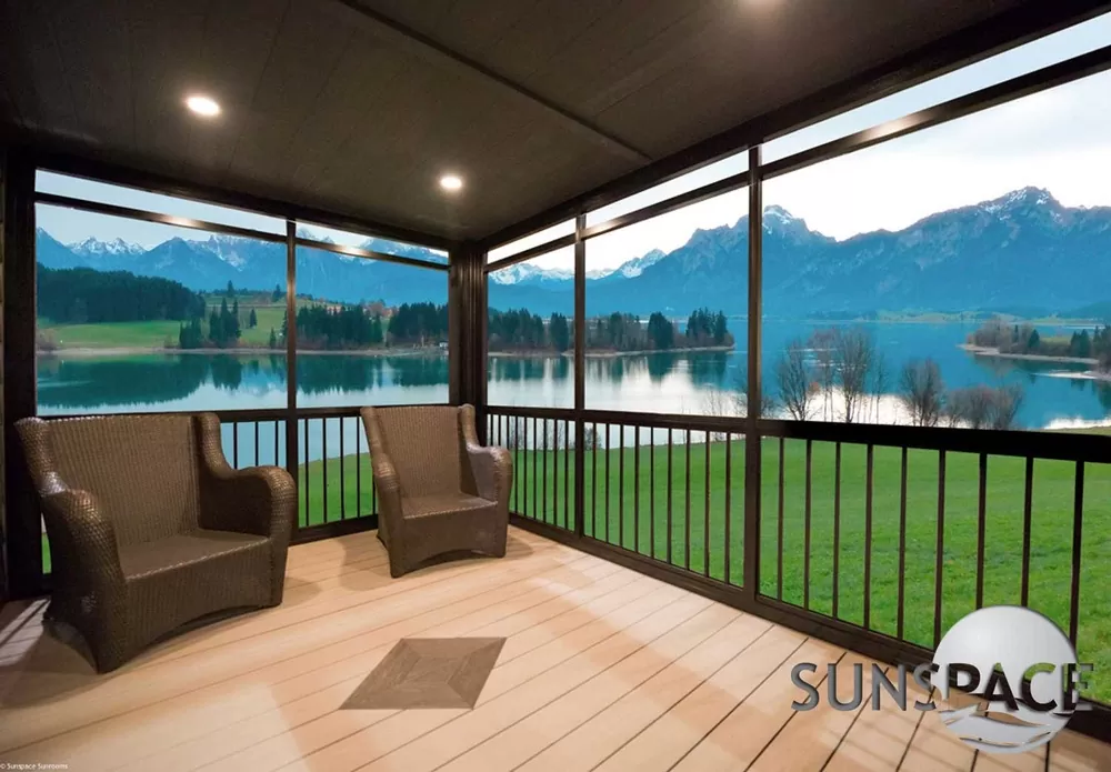 Interior of a Sunspace screen room overlooking a lake and mountains