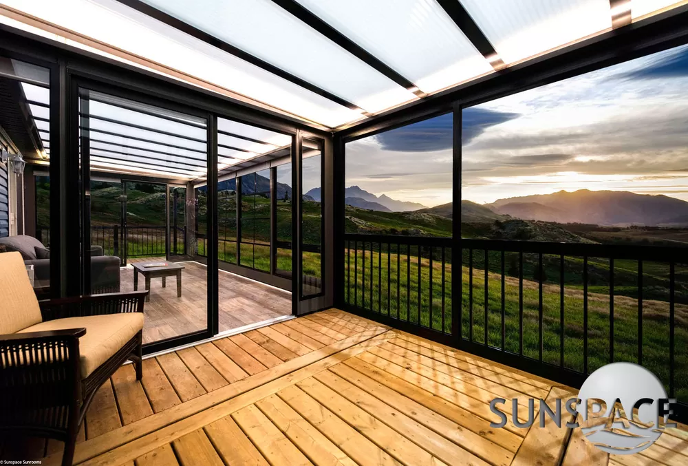 Sunspace screen room with black frames overlooking a mountain sunset